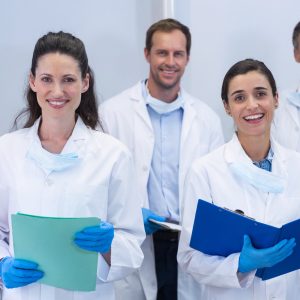 smiling-dentists-standing-in-dental-clinic.jpg